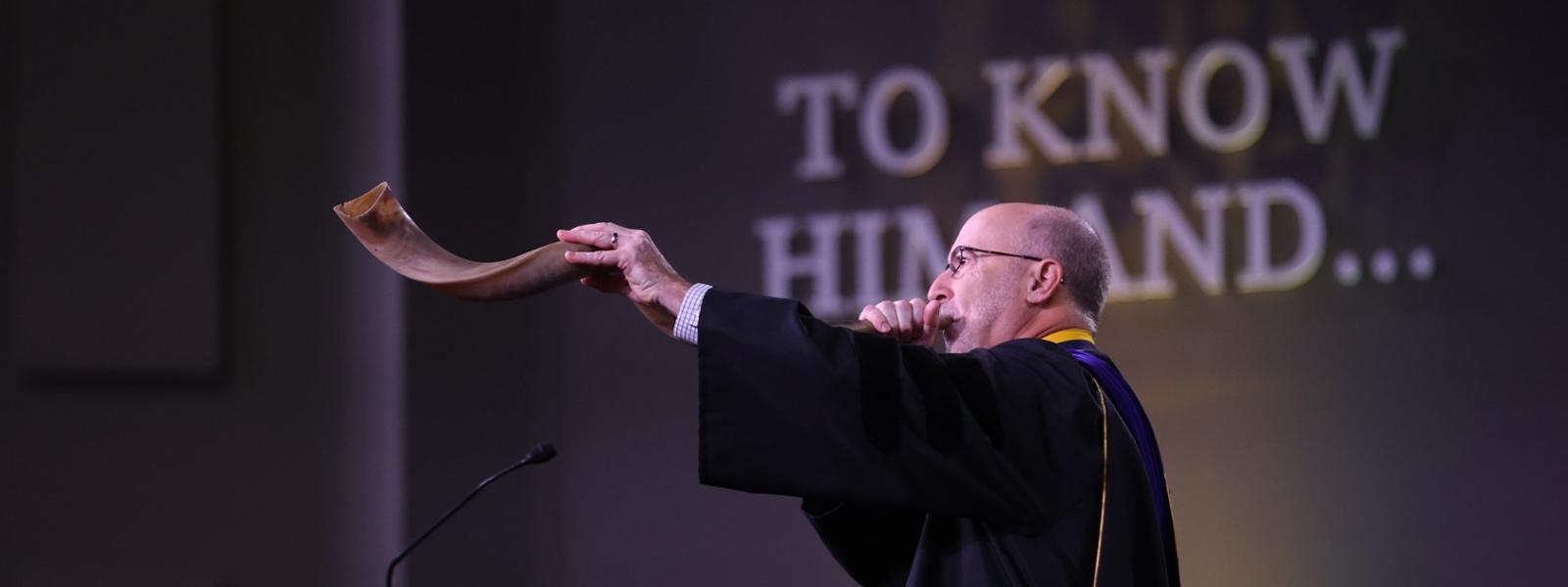 In a CIU tradition, Professor Emeritus Dr. Bryan Beyer blows the shofar at the end of commencement.