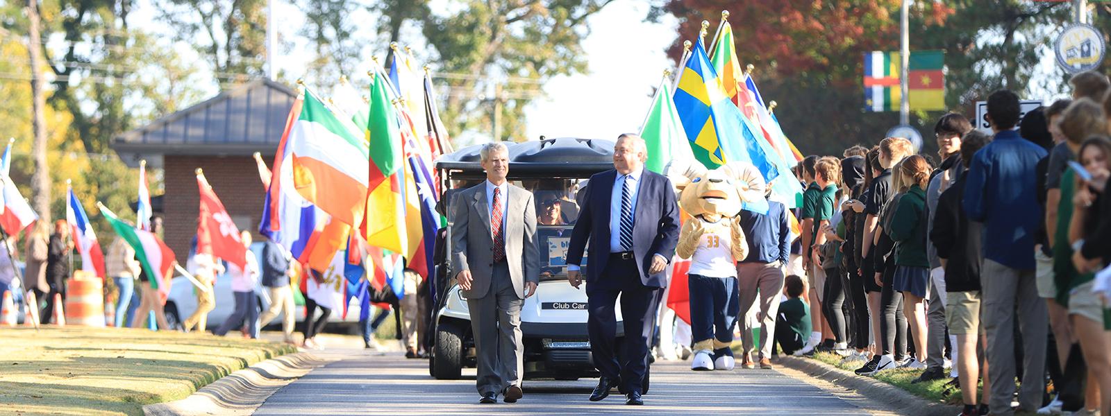 Chancellor Dr. Bill Jones (left) and President Dr. Mark A. Smith lead the parade of flags on International Boulevard. 