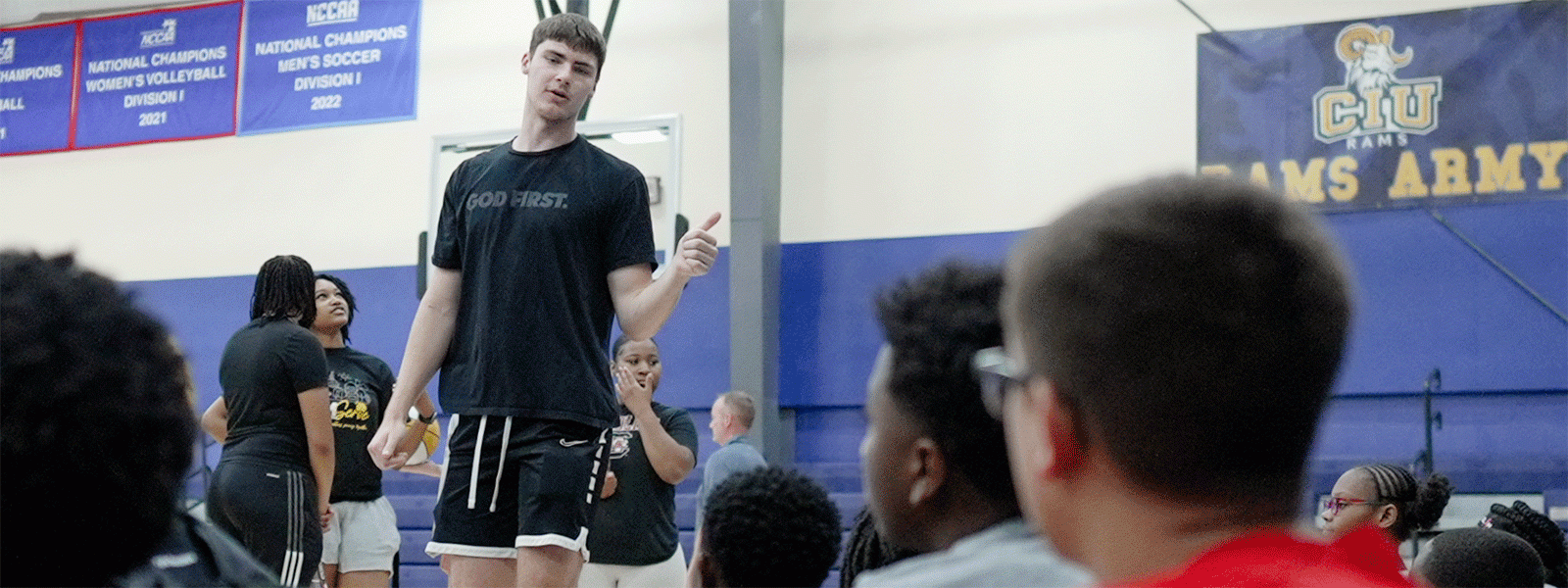 Rising sophomore Johnny Whysong, a member of the Rams men's basketball team, helps out at Hoop for Hope, a local outreach of CIU athletics. (Photo by Noah Allard) 