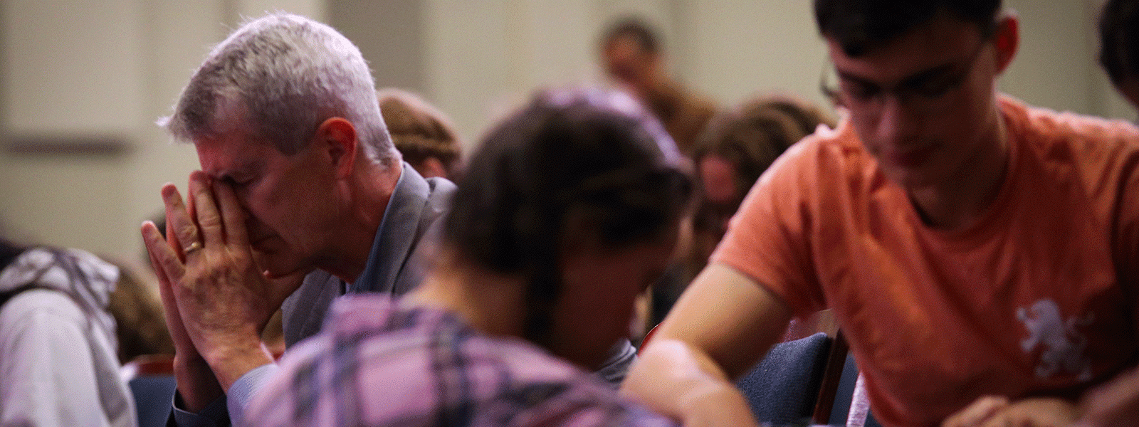 CIU President Dr. Bill Jones (left) joins students in prayer during Christian Life Conference. (Photo by Jonathan McGaha, CIU student photographer)