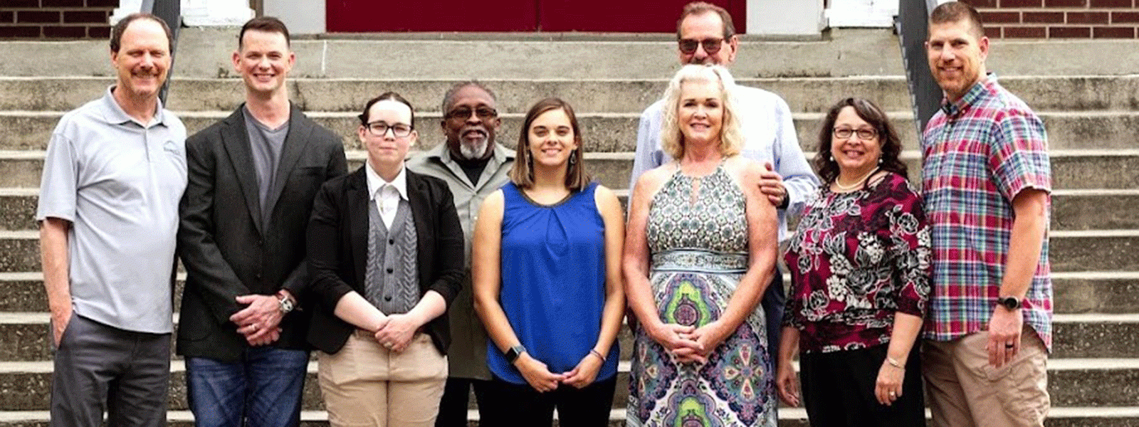 Posing at Hillcrest Church following a ribbon cutting for the Bridge of Hope-Gaston: (l-r) Paul Bishop of Bridge of Hope in Lexington; Josh McGee, Hillcrest associate pastor; counselor Karis Johnson; counselor Craig Boxwell; counselor Juliana Cook; Director Steve McGee and his wife Adanna; Assistant Director Linnette Mullin; CIU Counseling Professor Seth Scott. (Photo by Garrison Mullin of Garrison's Photography) 