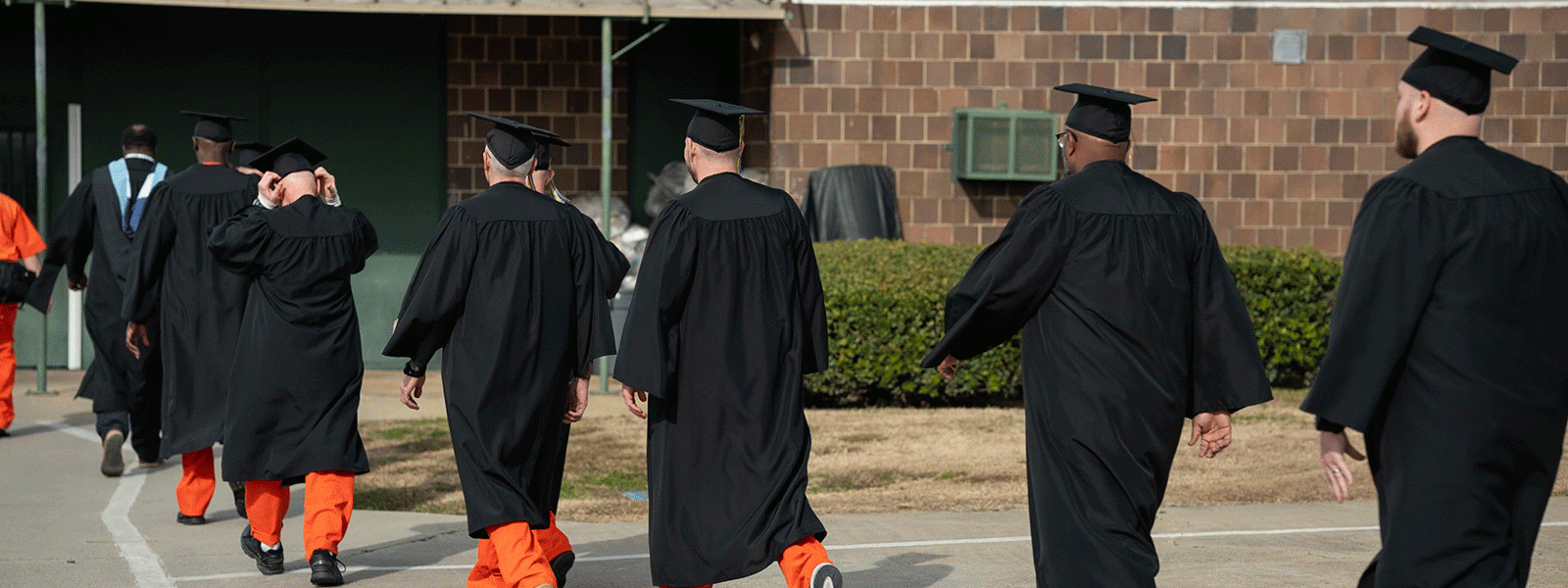 CIU Prison Initiative students walk across the prison yard to their commencement ceremony. (Photo by Noah Allard)