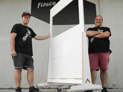 CIU alumnus Joe Bradford (right), co-owner of Fiasco, displays a COVID-19 shield. (Photo: Fiasco)