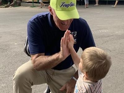 Dr. Dave Bireline gets a high-five from a youngster in Moldova. (Photo: Roads of Hope) 