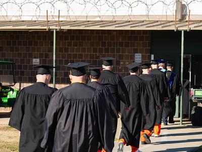 CIU Prison Initiative graduates "walk the yard" to their commencement ceremonies. (Photo by Noah Allard)