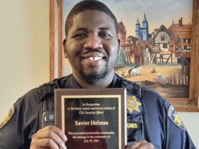 CIU Security Officer Xavier Holmes displays his plaque. 