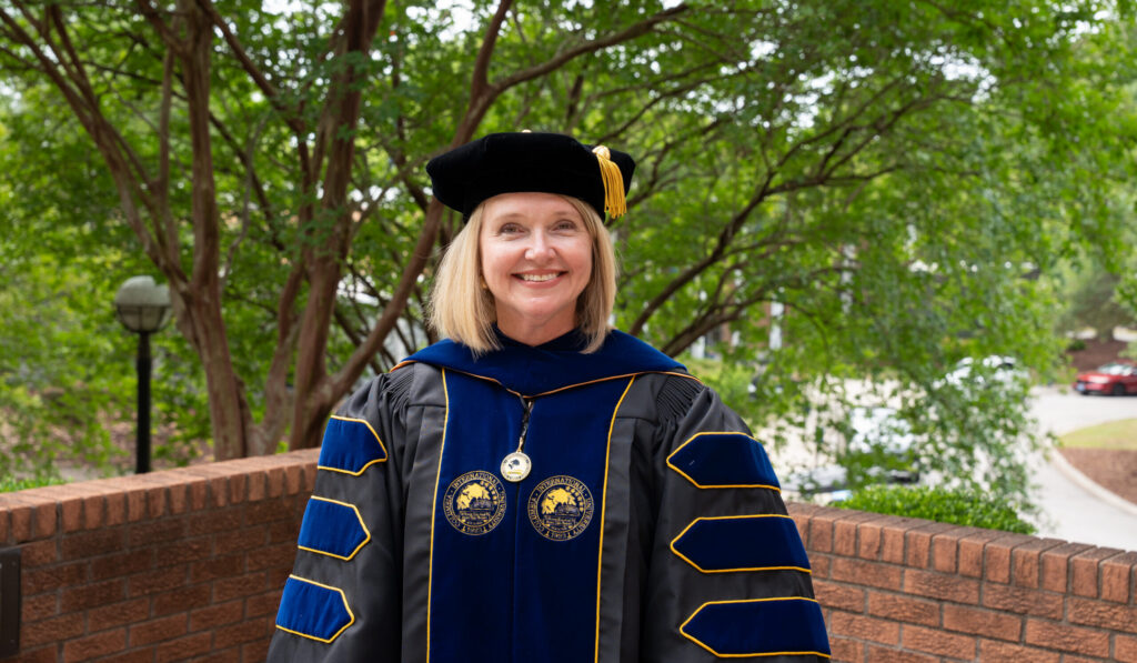 Dr. Brantlee Taylor in doctoral regalia following her hooding ceremony at Columbia International University