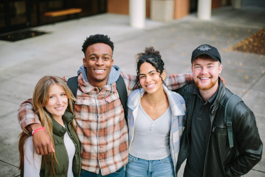 Four CIU students from fall 2024 stand together on campus, representing a Christ-centered university community focused on faith, learning, and belonging.