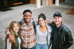 Four CIU students from fall 2024 stand together on campus, representing a Christ-centered university community focused on faith, learning, and belonging.