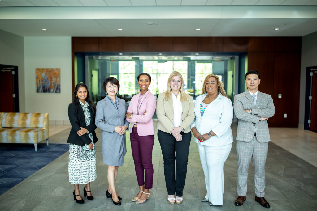 Columbia International University students and faculty standing together in the lobby of the William H. Jones Center, including Dr. Amy DuBois, Dean of the Cook School of Business