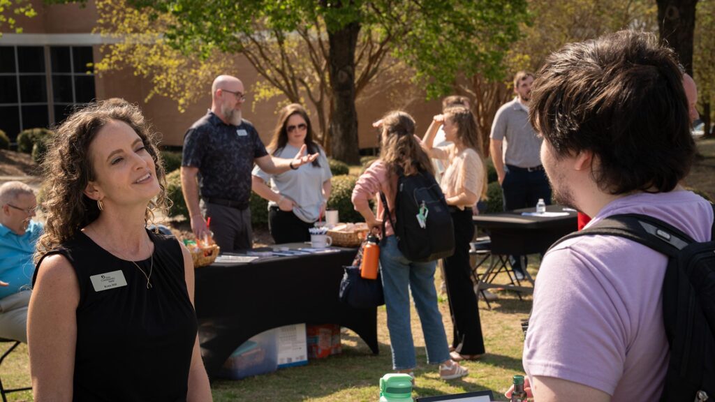 A representative from First Community Bank chats with CIU students.