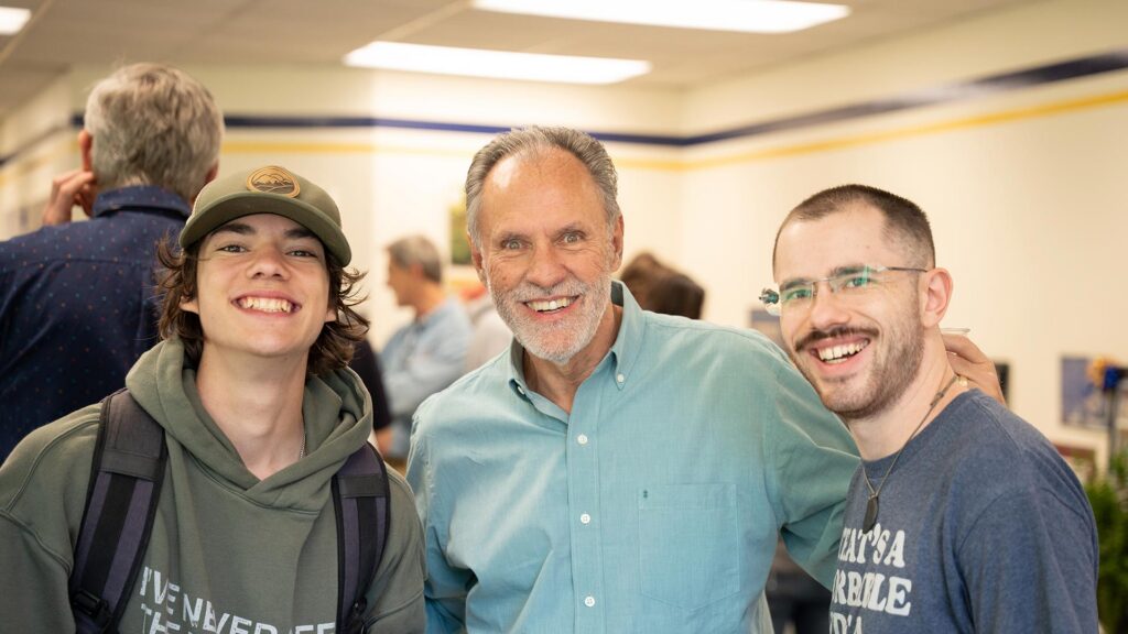 Dr. Ken Rife poses with students a retirement party