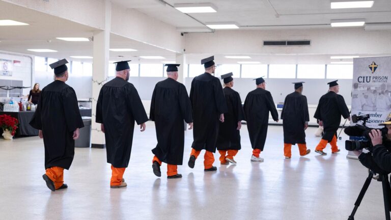 CIU Prison Initiative students walk at commencement.
