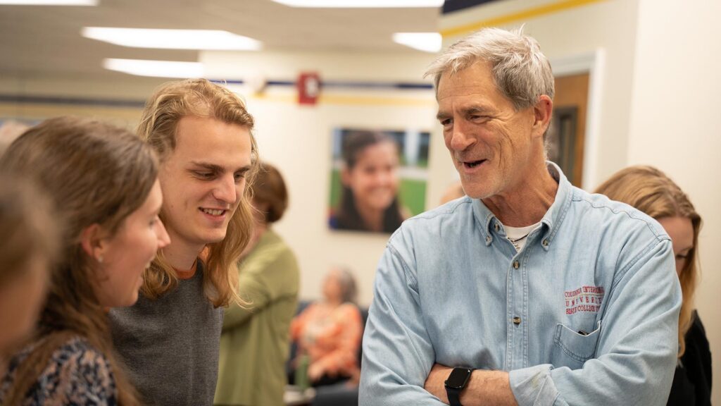 Dr. Rod Lewis chats with students.