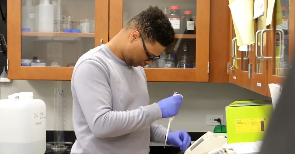 Joshua Neath, CIU biology student, using a pipette during lab research