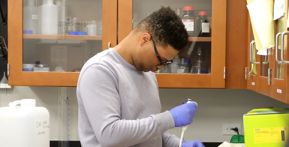 Joshua Neath, CIU biology student, using a pipette during lab research